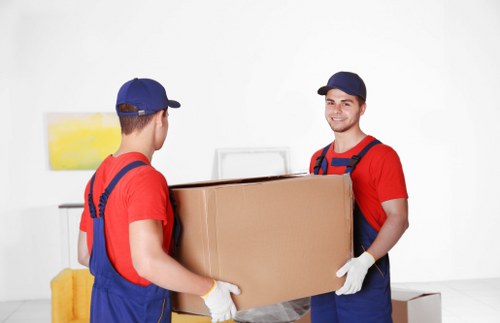 Driver and helper transporting boxes for a Kensington customer